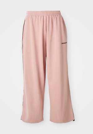 Mjuka rosa vida sweatpants med elastisk midja, sidofickor och liten mörk logotext på övre vänstra låret.
