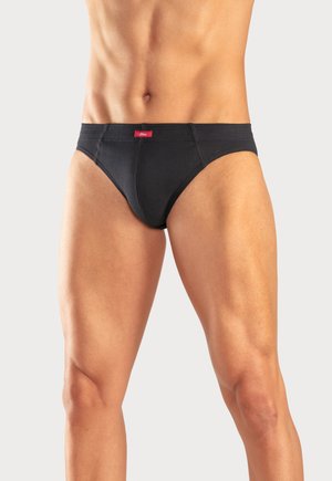Schwarze Baumwollunterhosen mit glatter Textur, elastischem Bund und einem kleinen roten Logosticker an der Vorderseite. Figurbetontes Design für zusätzlichen Komfort.