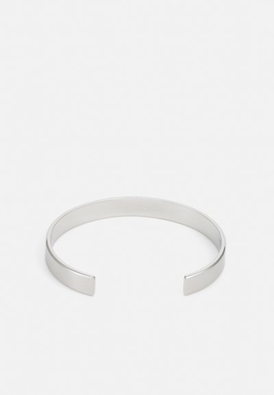 Silver metal cuff bracelet with a smooth, polished finish, featuring an open design and squared ends for a minimalist look.
