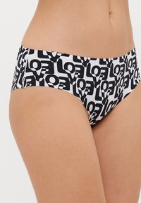 Svart och vit bikiniunderdel med ett upprepande logomönster, tillverkad av stretchigt material för en bekväm passform och standardtäckt.