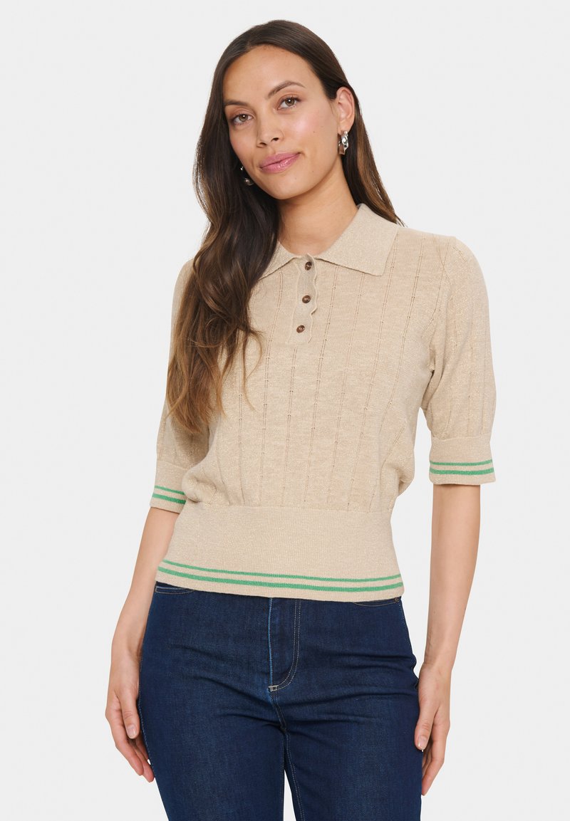 Beige short-sleeve sweater with a collared neck, featuring vertical ribbed texture, three buttons, and green striped accents at the cuffs and hem.