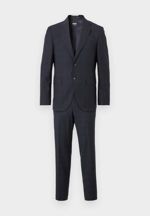 Tume sinine kahekordne ülikond peene ruudumustriga, kahe nööbiga jakk snotškaeluse ja klapi taskutega ning sobiva lõikega püksid.