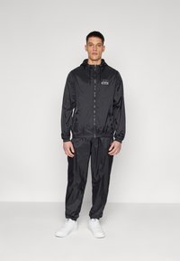 Ellesse - ROZINA JACKET AND PANT SET - Trenirka - black Miniaturna slika 1