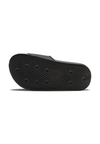 Black rubber slide sandal sole featuring a textured surface with circular grip points and a smooth, rounded toe.