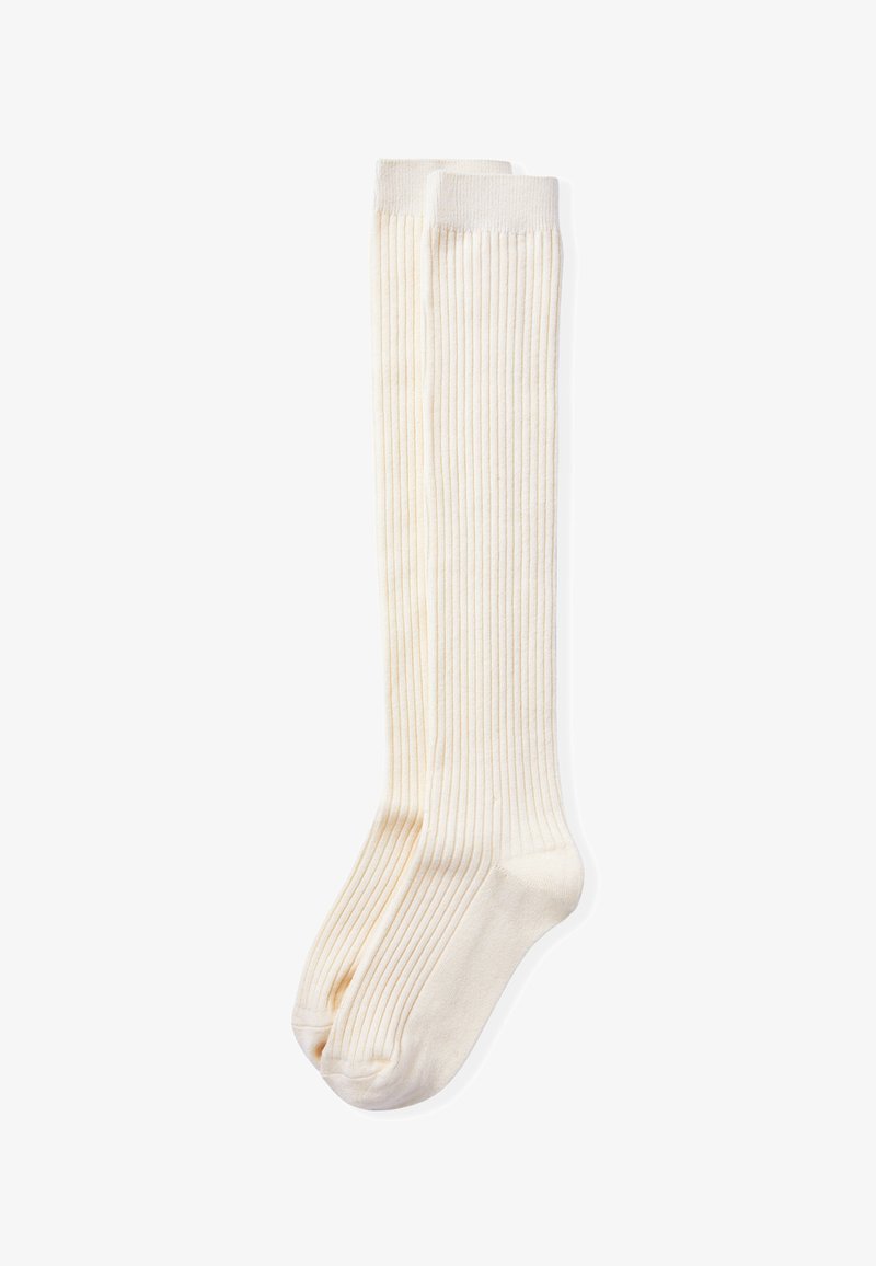Calcetas color crema hasta la rodilla, hechas de algodón ribeteado, con una textura suave y un diseño clásico con sutiles rayas verticales.