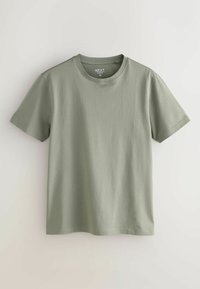 T-shirt ajusté à manches courtes de taille moyenne et col rond, de couleur verte douce, présenté à plat sur un fond neutre clair.