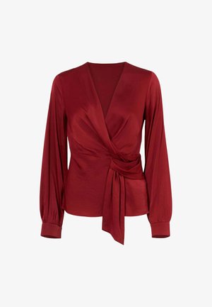 Blusa avvolgente rossa realizzata in tessuto liscio. Caratterizzata da maniche lunghe, scollatura a V profonda e un dettaglio di nodo asimmetrico in vita.