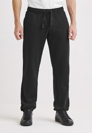 COMFORTABLE - Träningsbyxor - black