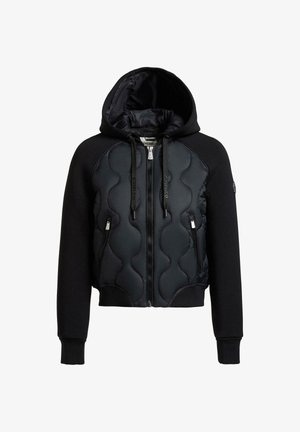 Giacca nera con cappuccio e zip frontale, pannello anteriore trapuntato, maniche lisce, due tasche con zip e cappuccio con coulisse.