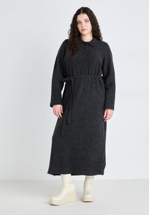 Long-sleeved, dark grey knit dress with a collared neckline, belted waist, and a straight silhouette, paired with cream platform boots.