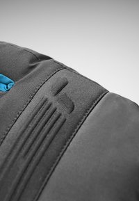 Black fabric with a smooth texture, featuring a blue accent and an embossed logo. Includes a ribbed pattern near the edge.