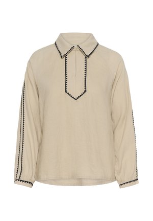 Bluza bej cu mâneci lungi, cu bordură neagră în zigzag pe guler, fanta frontală, dungi pe mâneci și mansete, având o închidere cu fermoar la nivelul gâtului.