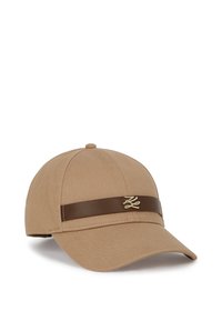 Tan fabric baseball cap with a curved brim. Features a brown leather band and a small gold emblem on the front. Textured material.