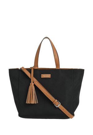 Sac cabas noir avec poignées en cuir marron, sangle d'épaule réglable, détail pompon et petite étiquette logo rectangulaire à l'avant.