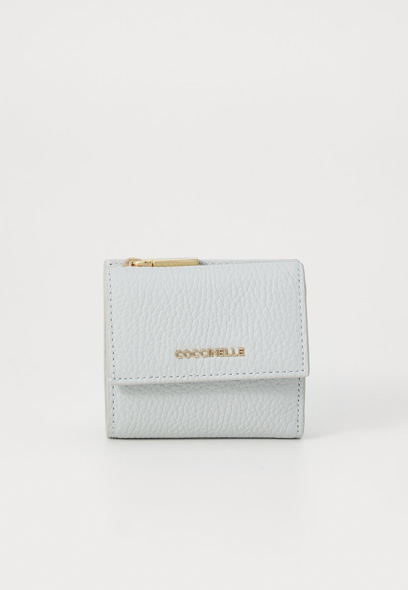 Light blue leather wallet with textured finish, gold logo detail, and zip closure. Compact design with a fold-over flap and card slots.