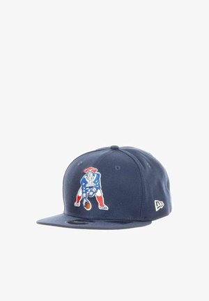 Navy blue baseball cap with vintage-style logo of a football player in red, white, and blue crouching to snap the ball.