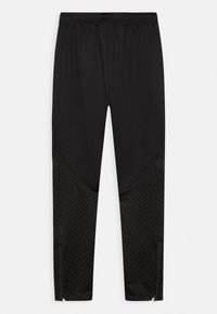 Pantalons de sport noirs avec une texture lisse, dotés d'une partie inférieure à motifs, de poches latérales et de zippers aux chevilles pour un ajustement.