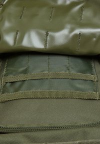 Olive green tactical pouch with a glossy top layer and textured base. Multiple stitched sections and fabric webbing for attachment.