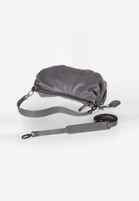 Borsa in pelle grigia con una forma morbida e gonfia. Presenta una chiusura con zip, una tracolla removibile e una consistenza liscia. Include la lunghezza della tracolla regolabile.