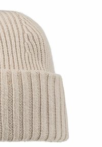 Cream knit beanie with ribbed texture, featuring a folded cuff and soft fabric. The overall shape is rounded and designed for comfort.