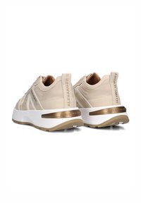 Beige sneakers met een gladde bovenkant, gouden accenten op een witte chunky zool en een geprofileerde paneel op de hak met reliëfbranding.