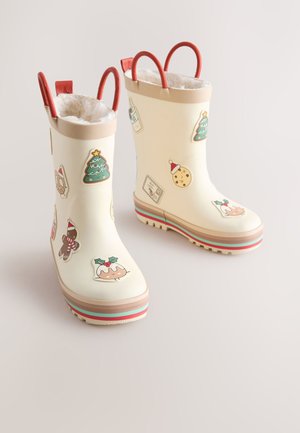 Bottes de pluie en caoutchouc blanc ornées d'autocollants colorés sur le thème de Noël, avec des boucles rouges et une doublure en peluche. Semelle épaisse à rayures multicolores.