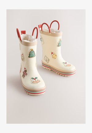 Bottes de pluie en caoutchouc blanc ornées d'autocollants colorés sur le thème de Noël, avec des boucles rouges et une doublure en peluche. Semelle épaisse à rayures multicolores.