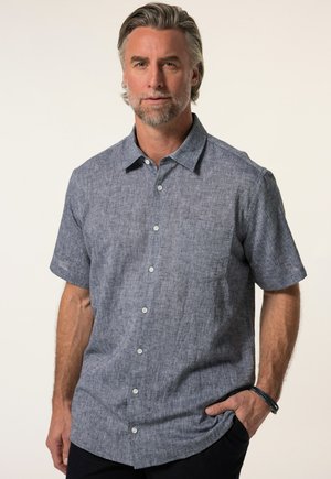 Camisa de botones de manga corta en un tejido texturizado azul-gris, con un bolsillo en el pecho y cinco botones visibles en la parte delantera.