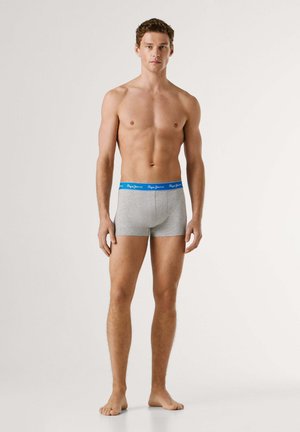 Boxer in cotone grigio con fascia in vita blu e logo del marchio bianco. Il design è aderente con un taglio che arriva a metà coscia.