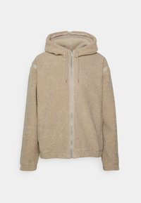 Beige fleece zip-up hoodie med en texturerad yta, dragsko i huvan och en framzipper. Har subtil branding på bröstet.