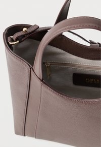 Brown textured leather handbag with two short handles, a zipped interior pocket, and a smooth upper edge. Gold-toned hardware accents.