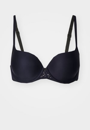 Navyblaues Unterwäsche-BH mit glatten Cups, verstellbaren Trägern und Spitzenakzent in der Mitte vorne für zusätzlichen Detail- und Textur.