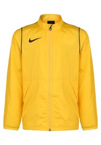 Giacca a vento gialla Nike con colletto alto, accenti neri, chiusura con zip, due tasche laterali e polsini elasticizzati. Materiale liscio e leggero.