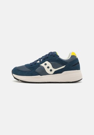 Navy blue sneaker with a mix of suede and mesh. Features white accents, a cushioned sole, and a yellow heel tab. Round toe design.