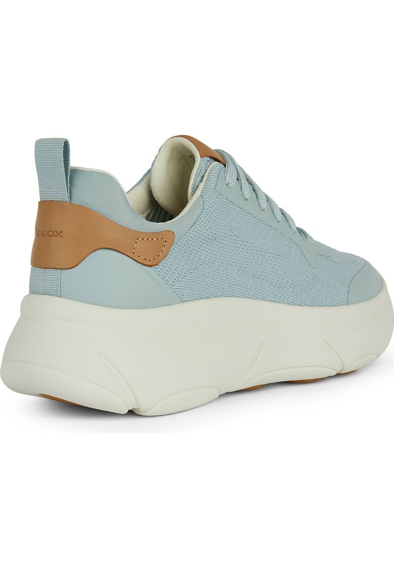 Zapatilla azul claro con un upper texturizado, detalles en marrón, suela blanca redondeada y diseño de cordones, que muestra un estilo atlético moderno.