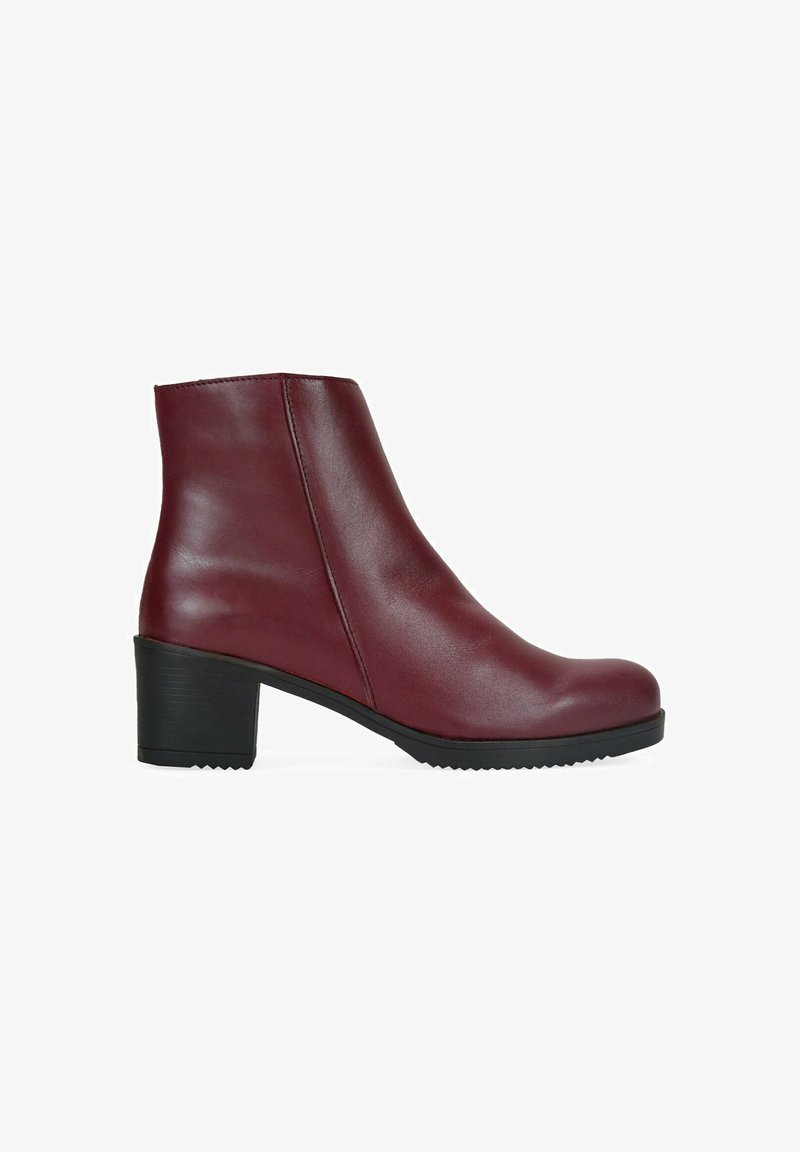 Botines de piel burdeos con punta redondeada, tacón negro de altura media y textura suave. Presentan una costura lateral como detalle de diseño.