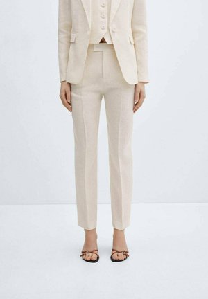 Beige linen suit consisting of a fitted blazer, vest, and tailored trousers. Features a clean design, smooth texture, and minimalist styling.