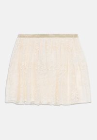 Helle cremfarbene Spitzenrock mit einem geschichteten Design und einem glitzernden goldenen elastischen Bund. Zarte florale Muster im gesamten Stoff.