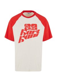 Red and cream short-sleeve t-shirt with baseball-style raglan sleeves. Features large red "karl kani" graphic print and rounded neckline.