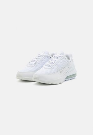 Pair of white Nike Air Max sneakers with mesh uppers, visible air cushioning in soles, and subtle silver Nike swoosh logos.