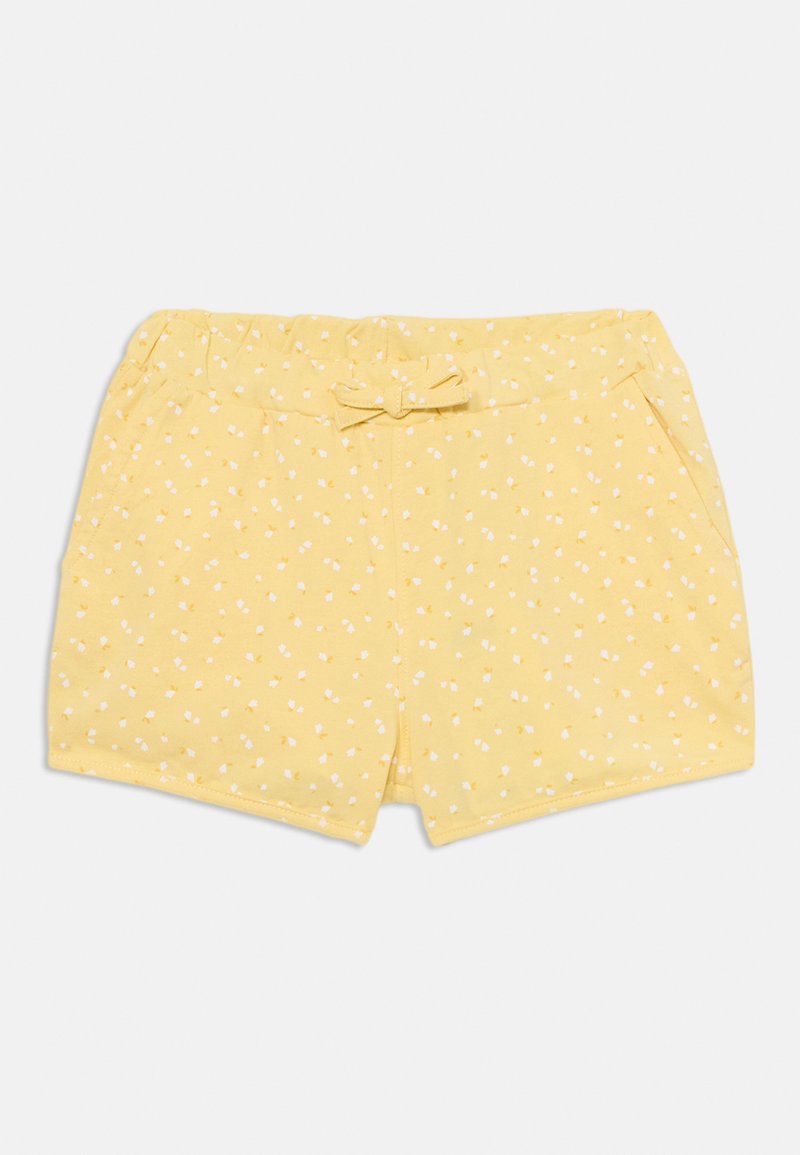 Gule shorts med en myk tekstur, med en sløyfe i livet og et mønster av små hvite blomster. Designet med sidelommer.