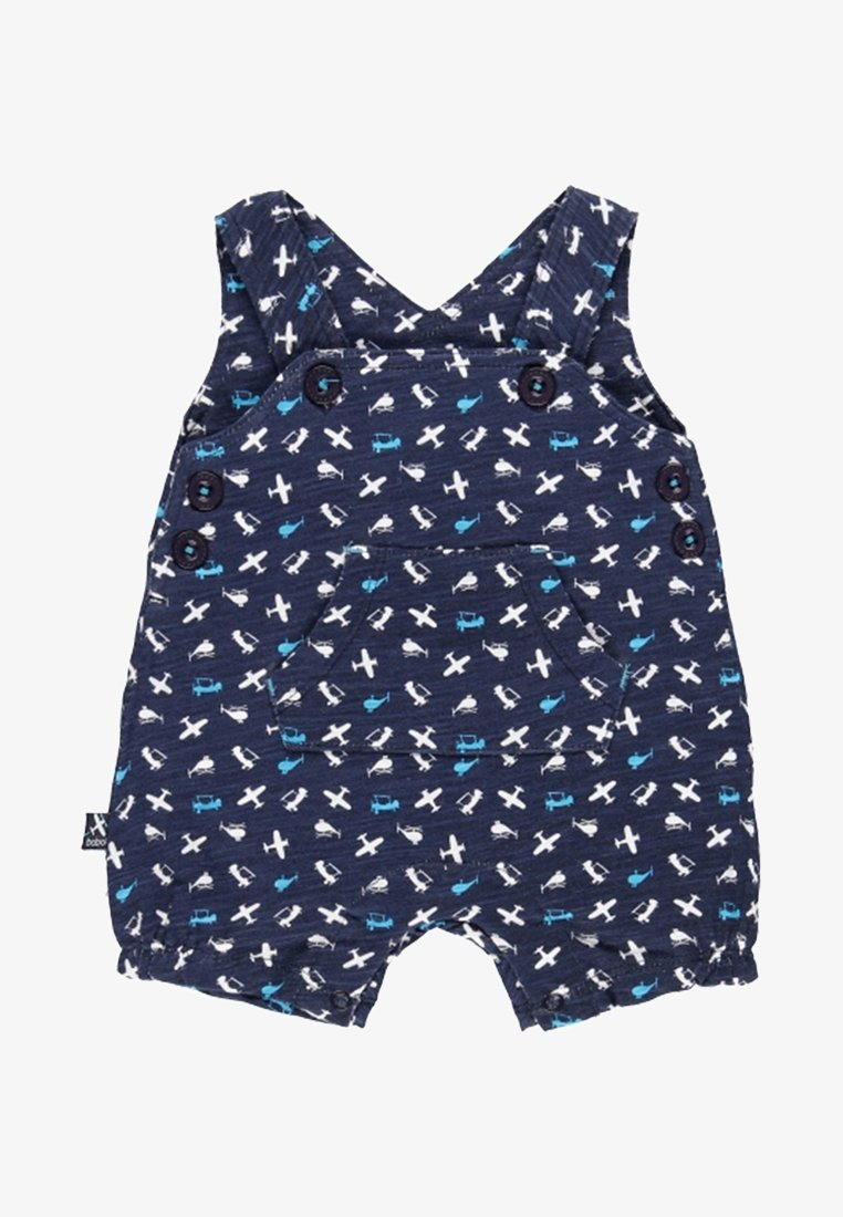 Combinaison bébé bleu marine avec imprimés d’avions et d’hélicoptères blancs et bleus, poche avant, bretelles boutonnées et ouvertures courtes aux jambes.
