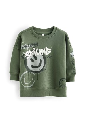Olivengrøn sweatshirt med ribbede manchetter og linning, prydet med store og små malede smiley-ansigter samt teksten "EVERYDAY SMILING 24/7" på fronten og ærmet.