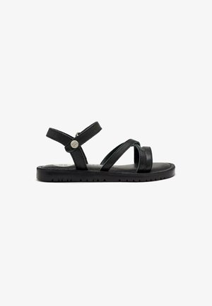 Sandalias de cuero negro con dos correas entrecruzadas, correa de tobillo ajustable y suela de goma texturizada. Diseño minimalista sin adornos.