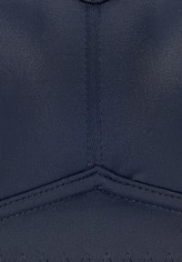 Navy blue fabric with a smooth texture, featuring stitched seams and a zigzag pattern along the lower edge. Lightweight and elastic material.