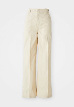 Beige vide bukser med høj talje, der har en glat stof og pænt pressede frontfald, sat mod en ensfarvet hvid baggrund.