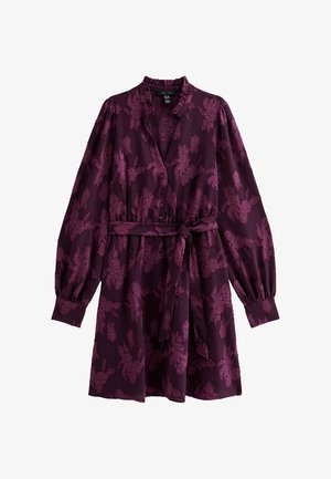 Abito viola con un motivo floreale, maniche lunghe con polsini elastici, chiusura frontale con bottoni e una cintura in vita per una silhouette aderente.