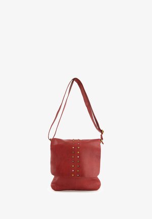 Red leather shoulder bag with a flat design, studded accents along the front, and a long, adjustable shoulder strap.