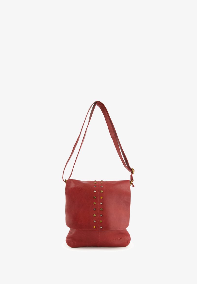 Red leather shoulder bag with a flat design, studded accents along the front, and a long, adjustable shoulder strap.