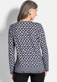 Langarmoberteil mit geometrischem Muster in Blau-, Lila- und Weißtönen, mit entspannter Passform und rundem Ausschnitt.